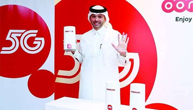 Ooredoo Group CTO Ahmad Abdulaziz al-Neama displays the new 5G devices.