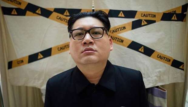 A Kim Jong Un impersonator, who goes by the name Howard X, poses while dressed up as the North Korean leader at a shopping mall in Hong Kong on Thursday.