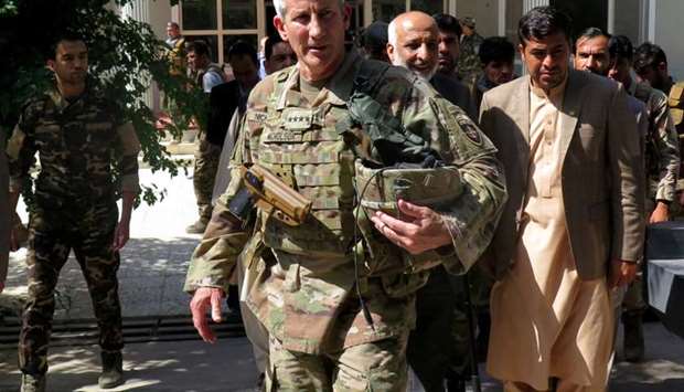 US Army General John Nicholson, commander of Resolute Support forces and US forces in Afghanistan, walks with Afghan officials during an official visit in Farah province, Afghanistan on May 19, 2018.