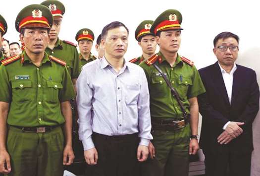 In this file photo, Nguyen Van Dai, centre, stands in a courtroom during his trial with other political activists in Hanoi.
