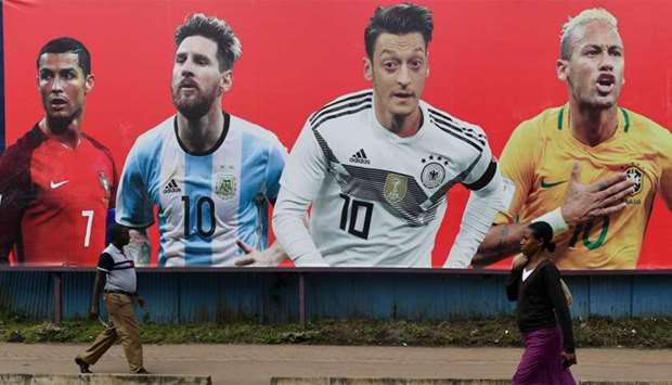 A football billboard displaying (From L) Portugal's forward Cristiano Ronaldo, Argentina's forward Lionel Messi, Germany's midfielder Mesut Ozil and Brazil's striker Neymar