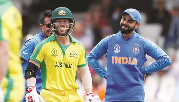 Indiau2019s Virat Kohli (right) and Australiau2019s David Warner share a laugh after a Jasprit Bumrah (not pictured) delivery hit the stumps but didnu2019t take the bails off, giving the batsman a reprieve. (Reuters)