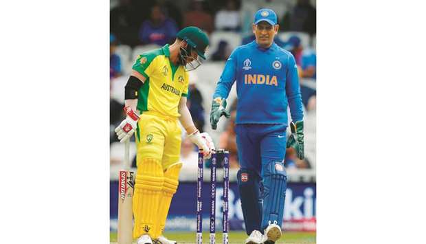 Australiau2019s David Warner (left) and Indiau2019s Mahendra Singh Dhoni look on after a Jasprit Bumrah delivery touched the formeru2019s stumps but did not dislodge the bails during the match on Sunday. (AFP)
