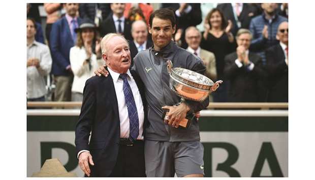 Spainu2019s Rafael Nadal (R) holds the Mousquetaires Cup (The Musketeers) as he poses with Australian tennis legend Rod Laver in Paris on Sunday.