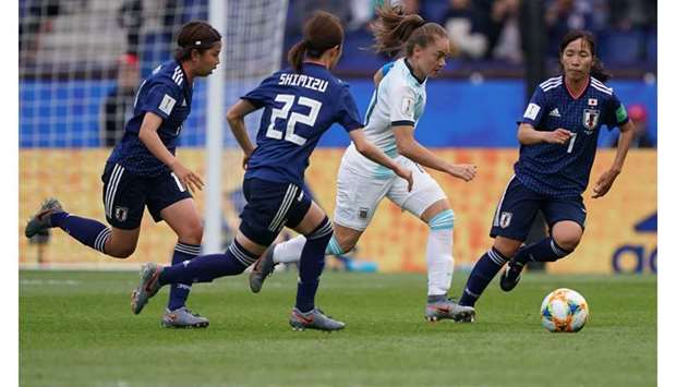 Argentinau2019s midfielder Estefania Banini (second right) attempts to get past Japanu2019s Risa Shimizu (second left) and Emi Nakajima (right) during the Womenu2019s World Cup Group D match at the Parc des Princes stadium in Paris yesterday. (AFP)
