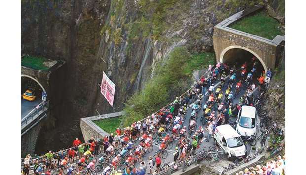 The pack rides through a tunnel of the San Boldo pass during stage nineteen of the 102nd Giro du2019Italia from Treviso to San Martino di Castrozza yesterday.
