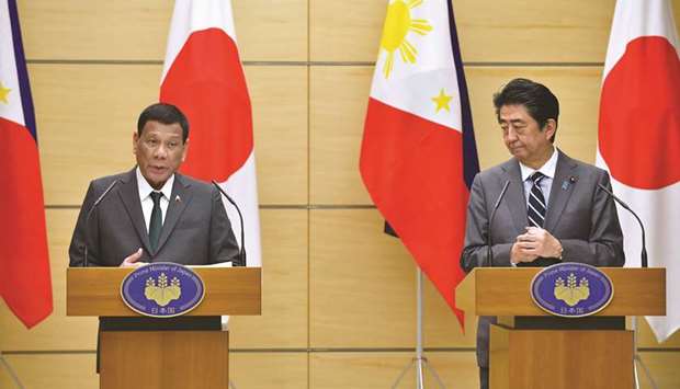 President Rodrigo Duterte and Japanu2019s Prime Minister Shinzo Abe hold their joint press statement at Abeu2019s office in Tokyo, yesterday.