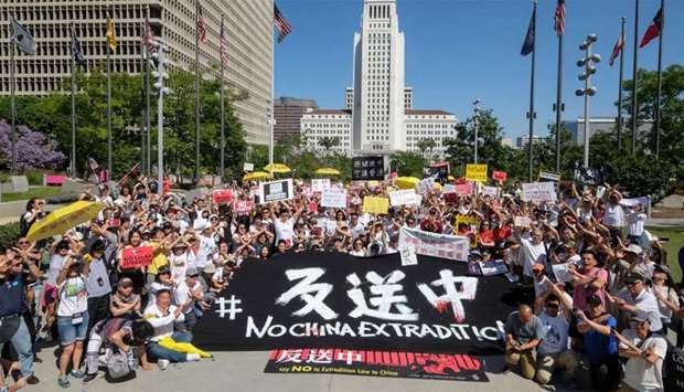Protesters gather near City Hall during a demonstration to protest against a controversial extradition law proposed by Hong Kong's pro-Beijing government to ease extraditions to China, in Los Angeles