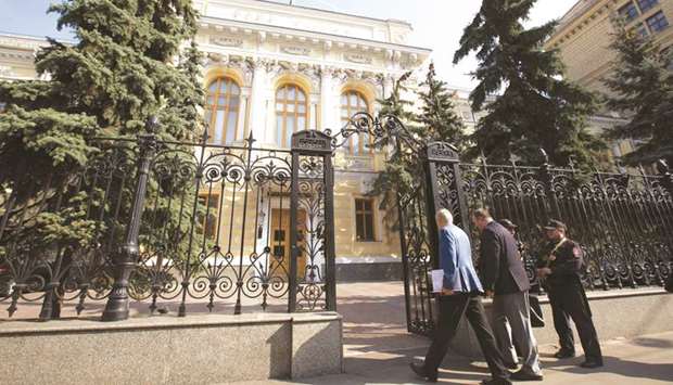 Visitors pass security to enter the headquarters of Russiau2019s central bank in Moscow. The Bank of Russia made the change to its pricing policy this year, saying it would buy from dealers at a level slightly below the benchmark London gold price.