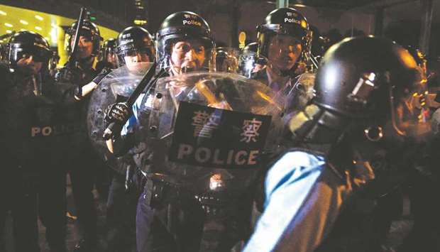 Police charge protesters after a rally against a controversial extradition law proposal in Hong Kong yesterday.