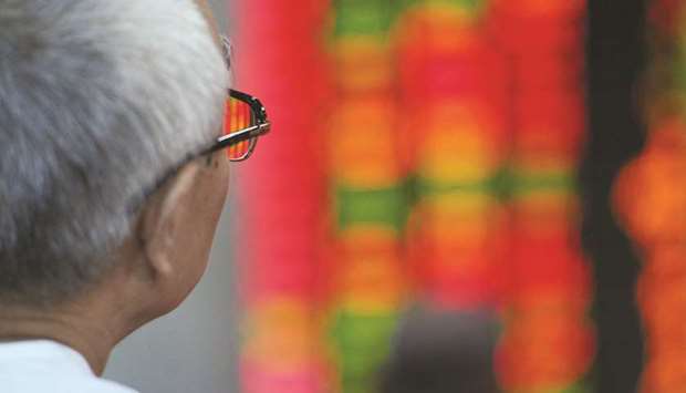 An investor watches stocks at a securities exchange in Shanghai (file). With US President Donald Trump ratcheting up pressure on China via trade tariffs and a crackdown on one of its biggest technology companies, the country finds itself at risk of being shut off from swathes of the global technology supply chain.
