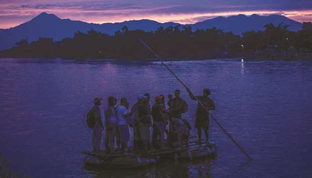 Central American migrants and locals arrive in Ciudad Hidalgo in Chiapas State, Mexico, after illegally crossing the Suchiate river from Tecun Uman in Guatemala in a makeshift raft, yesterday. In the framework of Mexicou2019s deal to curb migration in order to avert US President Donald Trumpu2019s threat of tariffs, Mexicou2019s Foreign Minister Marcelo Ebrard said Mexico will discuss a u201csafe third countryu201d agreement with the US.