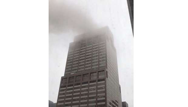 Smoke is seen rising from a building after a helicopter crash in New York City, New York, US. in this still image taken from a video obtained from social media.