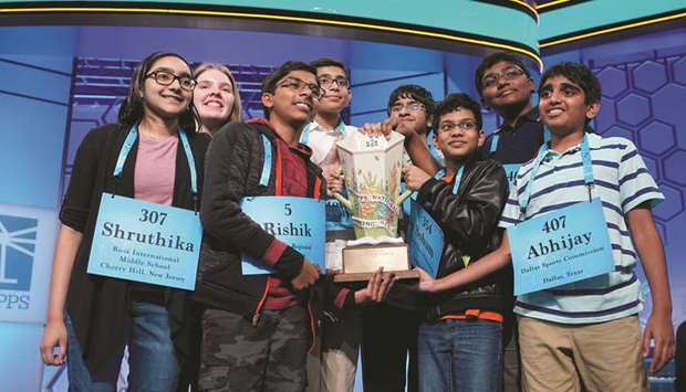 The eight winners celebrate following the final round of the 92nd annual Scripps National Spelling Bee at National Harbor in Oxon Hill, Maryland.