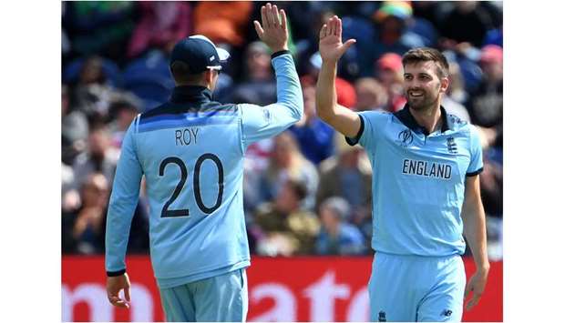 Englandu2019s Mark Wood (right) celebrates the wicket of Bangladeshu2019s Tamim Iqbal during the 2019 ICC Cricket World Cup match in Cardiff, Wales, on Saturday. (AFP)