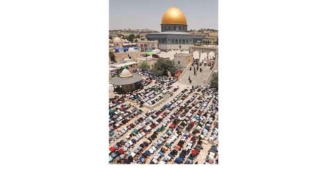 Palestinians pray during Al-Quds prayer at Al-Aqsa mosque compound in Jerusalem, yesterday.