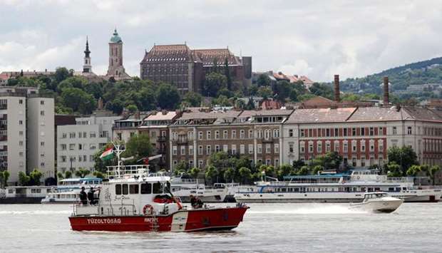 A fire brigade rescue ship and a police boat are seen at the site of a ship accident, which killed several people, near Margaret Bridge on the Danube river in Budapest, Hungary