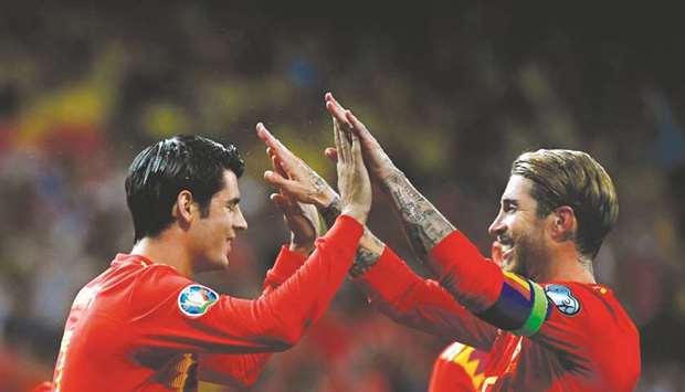 Spainu2019s Alvaro Morata (left) celebrates with Sergio Ramos after scoring a penalty during the UEFA Euro 2020 group F qualifying match against Sweden at the Santiago Bernabeu stadium in Madrid on Monday night. (AFP)