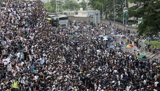 Protesters march along a road demonstrating against a proposed extradition bill in Hong Kong, China