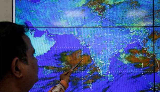 An India Meteorological Department scientist monitors Cyclone Vayu inside his office in Ahmedabad