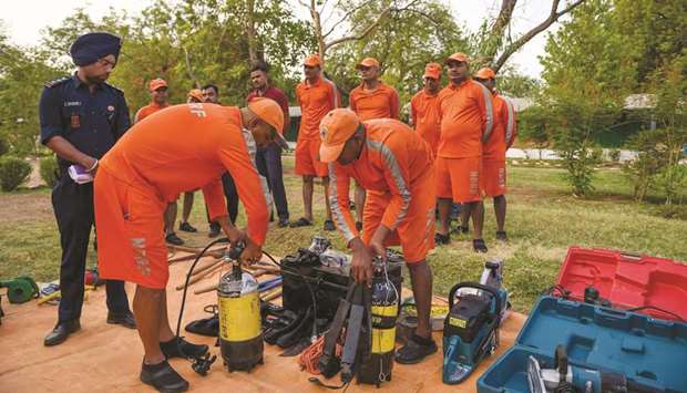 National Disaster Response Force (NDRF) personnel check emergency and rescue material at a camp in Chiloda (also called Naroda), some 40km from Ahmedabad yesterday.