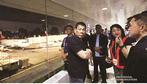 President Rodrigo Duterte talks to officials of the Ninoy Aquino International Airport (NAIA) as he conducts a surprise inspection at the NAIA Terminal 2 in Pasay City.