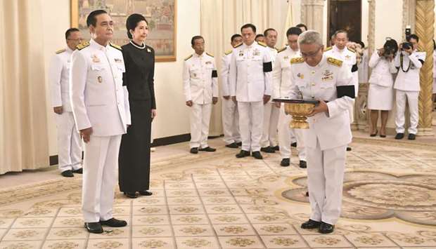Prayut Chan-O-Cha, left, attending the royal endorsement ceremony appointing him as Thailandu2019s new prime minister at Government House in Bangkok yesterday.