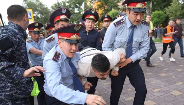 Law enforcement officers detain a man during an opposition rally held by critics of Kazakh President Kassym-Jomart Tokayev, who protest over his election in Almaty.