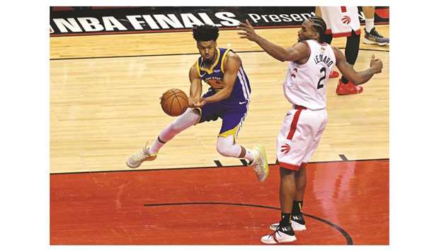 Golden State Warriors guard Quinn Cook (left) passes the ball against Toronto Raptors forward Kawhi Leonard during the fourth quarter of game five of the 2019 NBA Finals at Scotiabank Arena in Toronto, Canada, on Monday. (USA TODAY Sports)