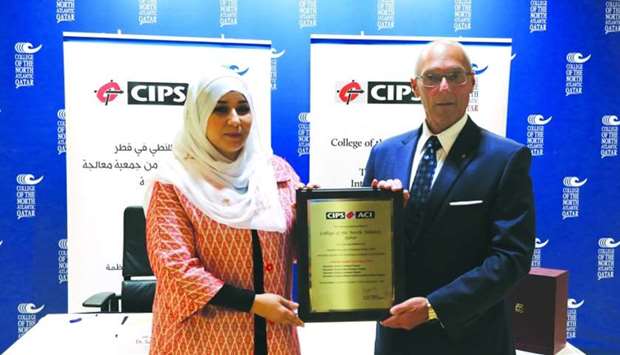 CNA-Q's Dr Samah Gamar receiving the re-accreditation plaque from CIPS' Gerald Caissy.