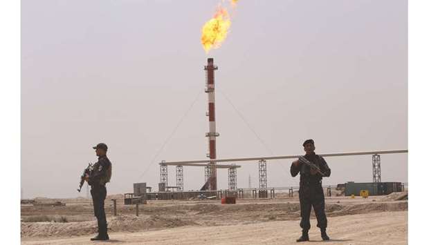 Members of the oil police stand on guard near the West Qurna-1 oilfield, which is operated by Exxon Mobil, near Basra on May 20. Exxon employees will start returning to Iraqu2019s West Qurna oilfield today after the government agreed to provide extra security, two senior Iraqi oil  officials told Reuters on Friday.