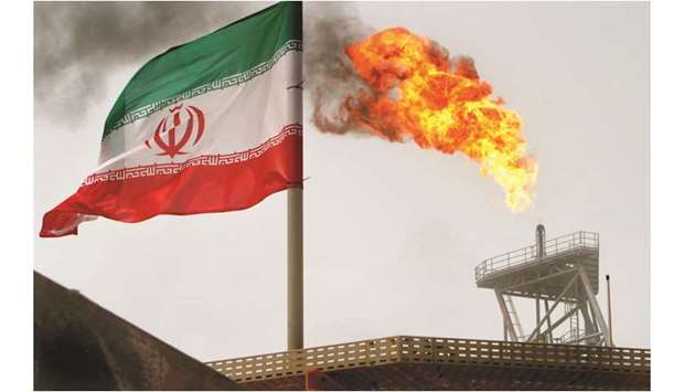 A gas flare on an oil production platform in the Soroush oil fields is seen alongside an Iranian flag (file). The US State Department has sought to quash speculation that the Trump administration is easing its clampdown on Iranian oil exports after a sanctions waiver programme ended May 2, saying there was no softening in the American stance that any country buying Iranu2019s oil would be subject to penalties.