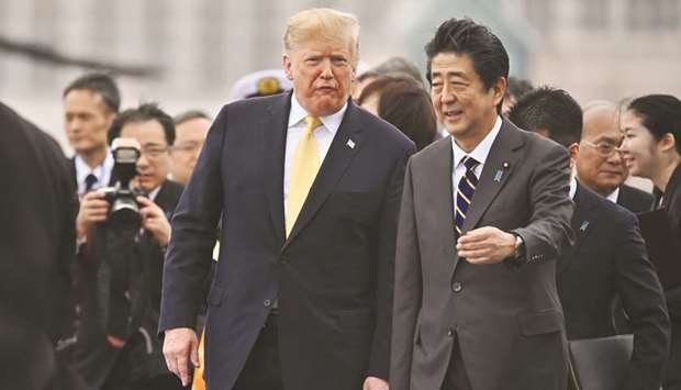 US President Donald Trump (left) walks with Japanu2019s Prime Minister Shinzo Abe as he leaves Japanu2019s navy ship Kaga in Yokosuka last Monday. At a joint press conference Trump dismissed concerns about the latest North Korean missile tests u2013 breaking not just with Abe, but also with his own advisers.
