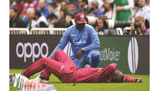 West Indiesu2019 Andre Russell gets medical attention on the side of the pitch during the match against Pakistan in Nottingham on Friday. (AFP)