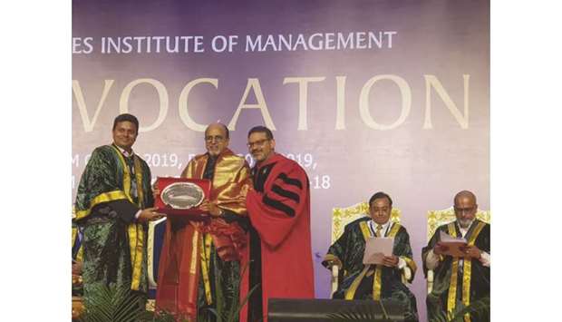 Doha Bank CEO Dr R Seetharaman receiving a token during the convocation ceremony.