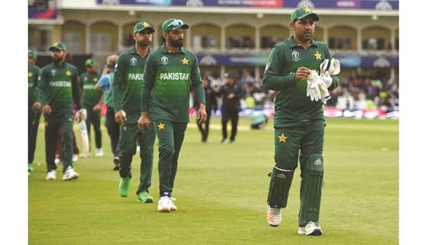 Pakistan captain Sarfaraz Ahmed (right) leads his players off the field after the loss to West Indies in the 2019 ICC Cricket World Cup at Trent Bridge in Nottingham on Friday. (AFP)