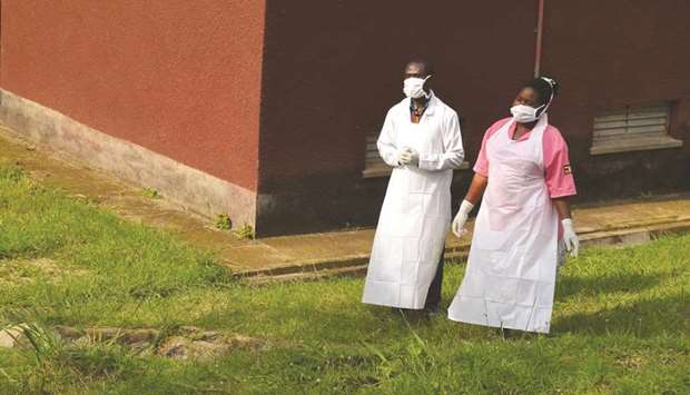 Ugandan medical staff are seen as they inspect the Ebola preparedness facilities at the Bwera general hospital near the border with the Democratic Republic of Congo, yesterday.