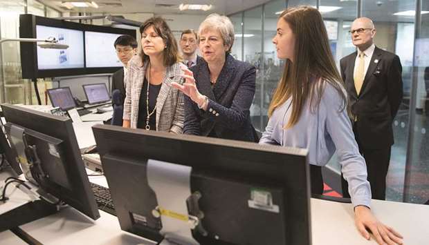 Prime Minister Theresa May visits Imperial College in London yesterday where she was shown machinery which converts carbon dioxide into oxygen after her announcement that the UK is to set a legally binding target to end its contribution to climate change by 2050.