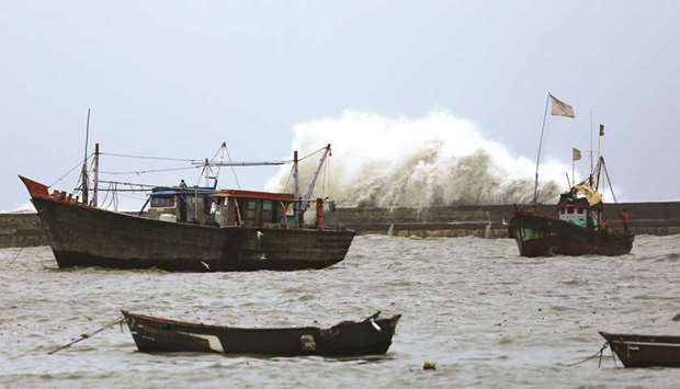 Waves crash against the jetty at a fishing harbour ahead of the expected landfall of Cyclone Vayu at Veraval, Gujarat, yesterday.