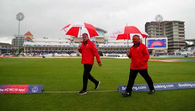 Umpires Marais Erasmus and Paul Reiffel after inspecting the pitch