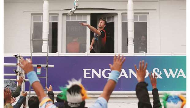 New Zealandu2019s James Neesham throws his gloves to the fans during a rain delay in the ICC Cricket World Cup match against India at Trent Bridge in Nottingham, United Kingdom, yesterday. (Reuters)