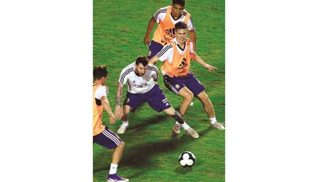 Argentinau2019s  Lionel Messi (2-L) and Juan Foyth (R) during a training session at Manoel Barradas Stadium in Salvador, state of Bahia, Brazil, yesterday.
