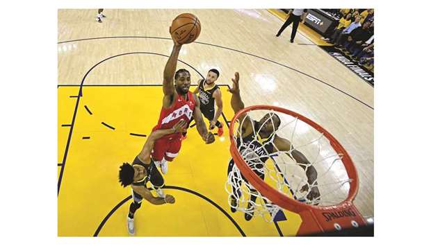 Toronto Raptors forward Kawhi Leonard shoots the ball against Golden State Warriorsu2019 Quinn Cook (4) and Andre Iguodala (9) in game six of the NBA Finals at Oracle Arena in Oakland, California. PICTURE: Kyle Terada-USA TODAY Sports