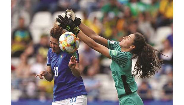 Italyu2019s forward Cristiana Girelli (left) scores past Jamaicau2019s goalkeeper Sydney Schneider during the Womenu2019s World Cup Group C match in Reims, eastern France. (AFP)