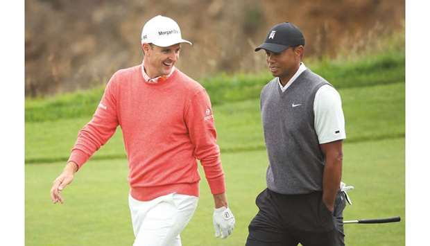 Justin Rose (left) and Tiger Woods walk on the course during the first round of the US Open at Pebble Beach Golf Links in Pebble Beach, California. (AFP)