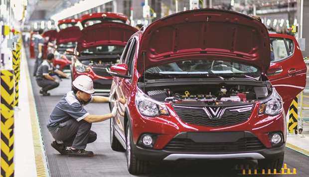 Workers operate the car assembly line at the new automobile plant of VinFast in Haiphong. VinFast said it will supply a domestic market that is rapidly expanding thanks to a mushrooming middle class with a growing appetite for cars u2013 though it will face stiff competition from well-established players.