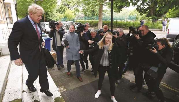PM hopeful Boris Johnson leaves his home in London yesterday.