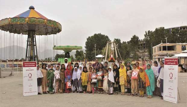 Participating children with Qatar Charity officials.