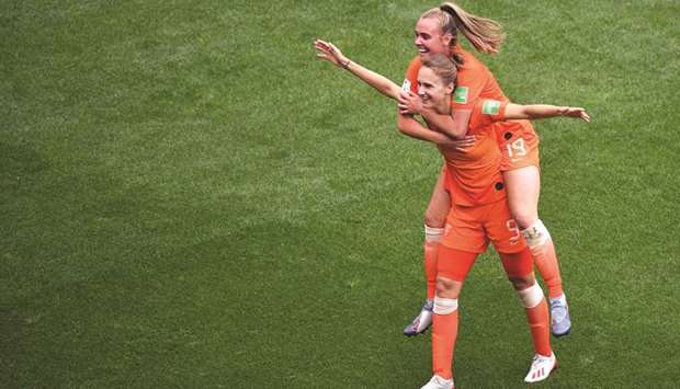 Netherlandsu2019 forward Vivianne Miedema (left) is congratulated by teammate Jill Roord after scoring a goal against Cameroon during the Womenu2019s World Cup Group E match at the Hainaut Stadium in Valenciennes, northern France. (AFP)