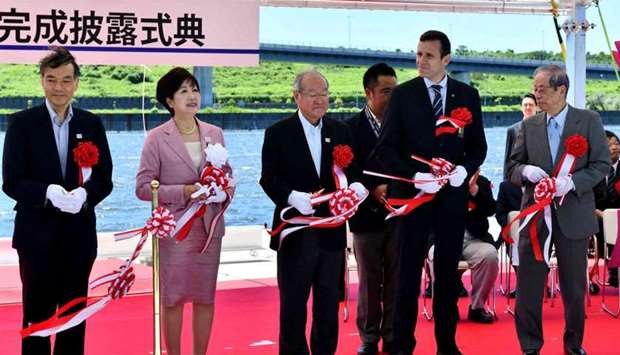 Tokyo metropolitan governor Yuriko Koike (2nd L), Jean-Christophe Rolland, president of the World Rowing Federation (2nd R) and other officials hold a tape cutting ceremony attends the Sea Forest Waterway opening ceremony in Tokyo